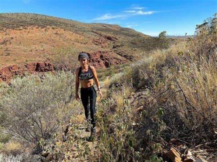 Jane Harber jogging by wearing black dress.
