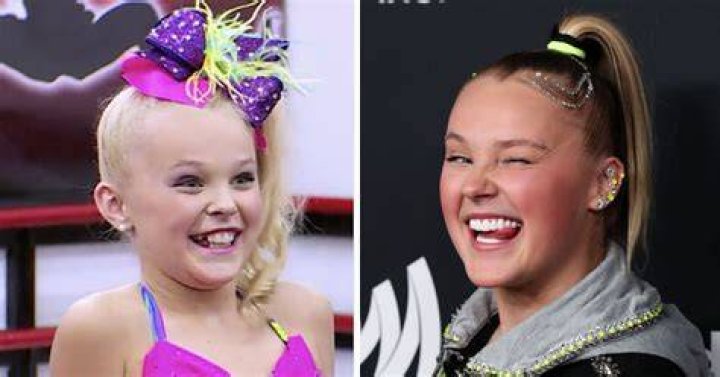JoJo Siwa jumping up in the air with a mic stand in her hand.
