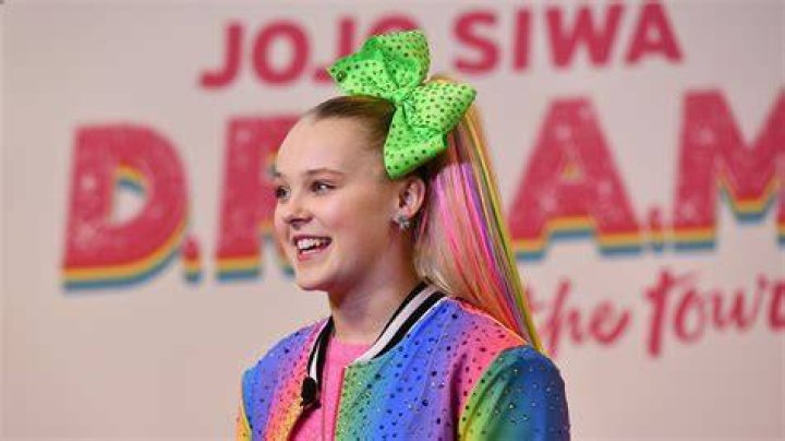 JoJo Siwa without her ponytail but with a yellow bow.
